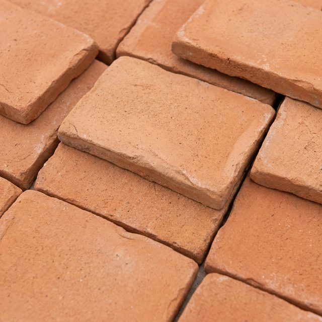 Unglazed handmade terracotta tiles in burnt orange