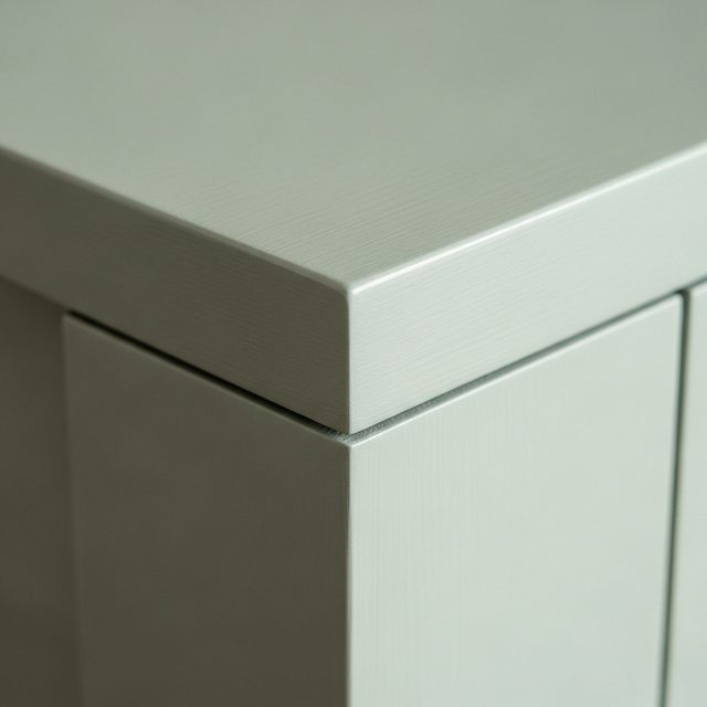 Hand-painted cabinet door corner in muted sage green